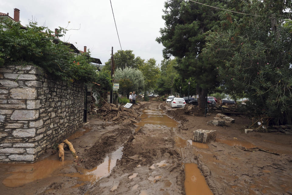 FILE - Mud covers a road after a record rainfall in Milina village, Pilion region, central Greece, on Sept. 6, 2023. The storms flooded 720 square kilometers (72,000 hectares), mostly prime farmland, totally destroying crops. They also swamped hundreds of buildings, broke the country's railway backbone, savaged local roads and bridges and killed tens of thousands of livestock. Thessaly accounts for about 5% of national economic output, and a much larger proportion of agricultural produce. (AP Photo/Thodoris Nikolaou, File)