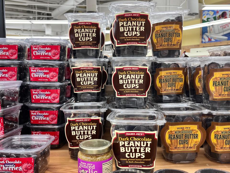 Clear plastic containers with brown and red labels for Trader Joe's dark-chocolate peanut-butter cups