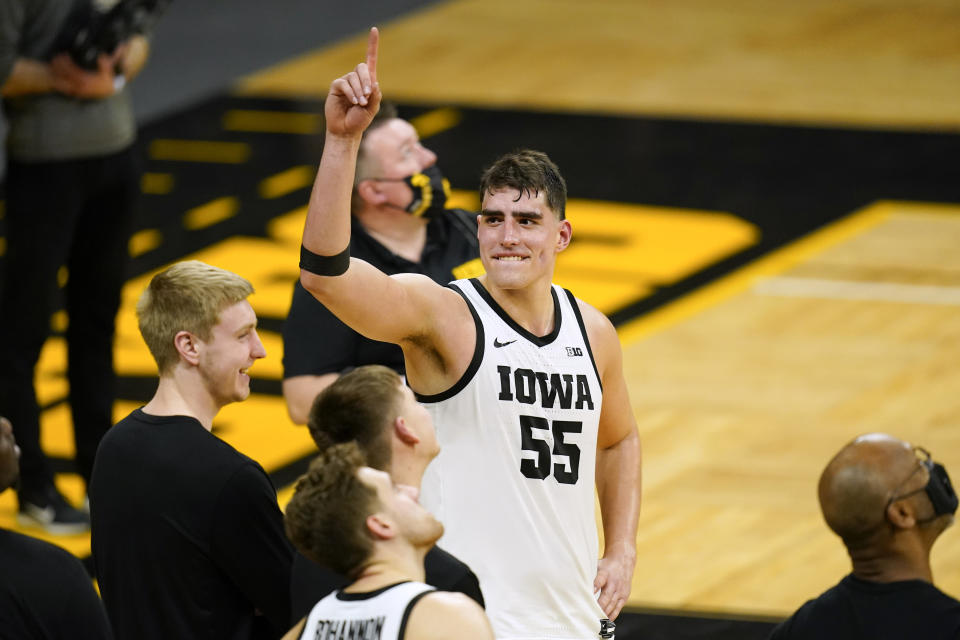 Iowa center Luka Garza (55) reacts during a video tribute following an NCAA college basketball game against Penn State, Sunday, Feb. 21, 2021, in Iowa City, Iowa. Garza became Iowa's all-time leading scorer in the game as Iowa won 74-68. (AP Photo/Charlie Neibergall)