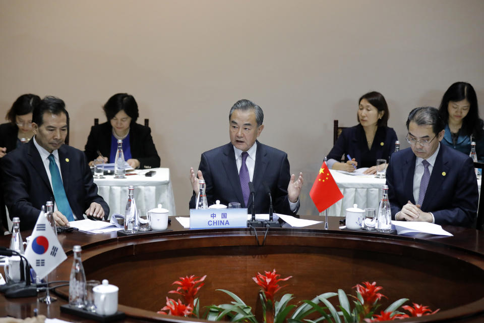 Chinese Foreign Minister Wang Yi, center, speaks with his South Korean counterpart Kang Kyung-wha and Japanese counterpart Taro Kono during their trilateral meeting at Gubei Town in Beijing Wednesday, Aug. 21, 2019. (Wu Hong/Pool Photo via AP)