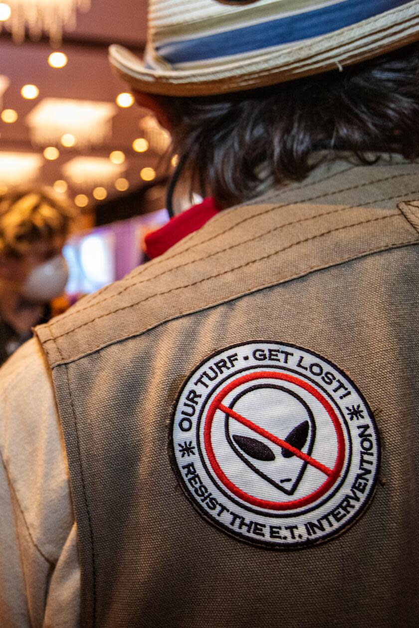 A closeup of a man's shoulder, with a patch that reads: 