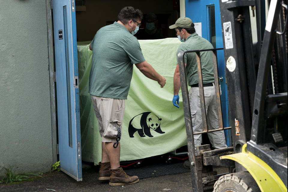 In this photo released by Xinhua News Agency, workers transfer a cage loaded with giant panda Ya Ya at the Memphis Zoo in Memphis, Tenn., on April 26, 2023. Ya Ya the giant panda landed in Shanghai Thursday, April 27 afternoon after departing from the Memphis Zoo, where it has spent the past 20 years on loan. (Liu Jie/Xinhua via AP)