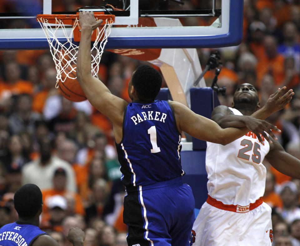 Duke’s Jabari Parker, left, jams against Syracuse’s Rakeem Christmas, right, in the second half of an NCAA college basketball game in Syracuse, N.Y., Saturday, Feb. 1, 2014. Syracuse won 91-89. (AP Photo/Nick Lisi)