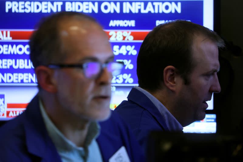 Traders work on the floor of the NYSE in New York