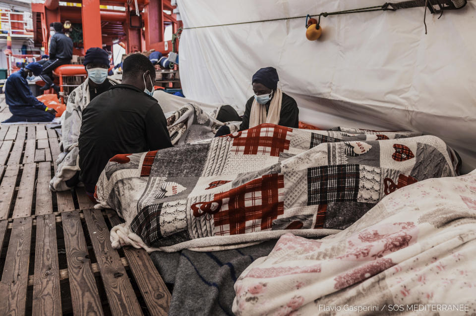 In this photo taken Friday, April 30, 2021 migrants rest aboard of the Ocean Viking during its navigation in the Mediterranean Sea. SOS Mediterranee said Saturday May 1, 2021 the Ocean Viking was sailing toward a Sicilian port with 236 migrants who were rescued days earlier in the Mediterranean from human traffickers' boats, while separately, Italy's coast guard and border police vessels brought 532 migrants rescued during the night to a tiny Italian island. (Flavio Gasperini/SOS Mediterranee via AP)