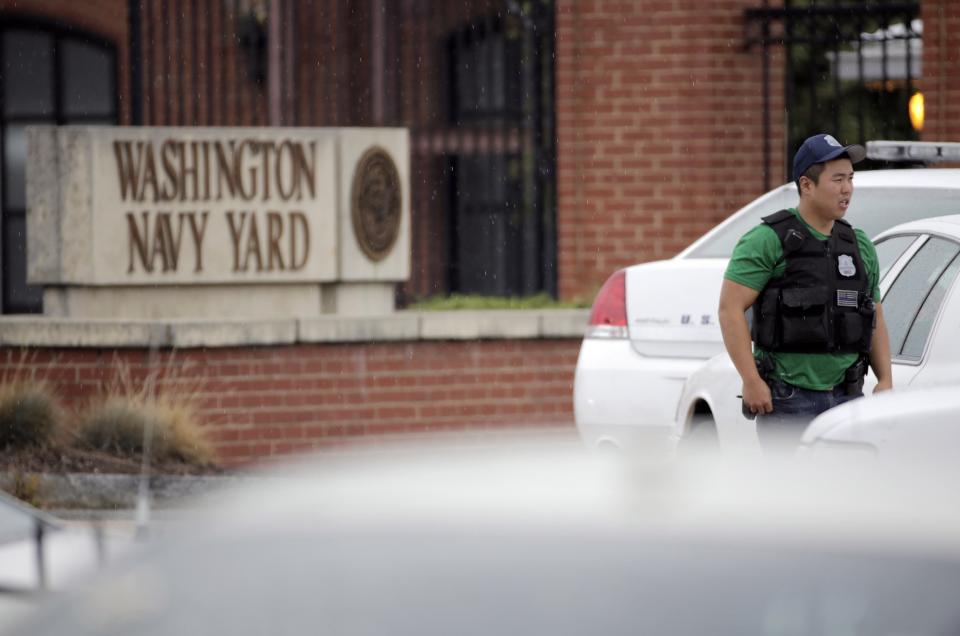 A law enforcement officer keeps bystanders back from the scene of a shooting at the Washington Navy Yard in Washington, September 16, 2013. The U.S. Navy said several people were injured and there were possible fatalities in the shooting at the Navy Yard in Washington D.C. on Monday. The Navy did not immediately provide additional details but a Washington police spokesman said earlier that five people had been shot, including a District of Columbia police officer and one other law enforcement officer. REUTERS/Jason Reed (UNITED STATES - Tags: CRIME LAW MILITARY)