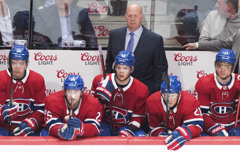 Montreal Canadiens coach Claude Julien and players Nick Suzuki (14), Ryan Poehling (25), Nick Cousins (21) and Max Domi watch from the bench during the third period of the team's NHL hockey game against the Chicago Blackhawks on Wednesday, Jan. 15, 2020, in Montreal. (Graham Hughes/The Canadian Press via AP)