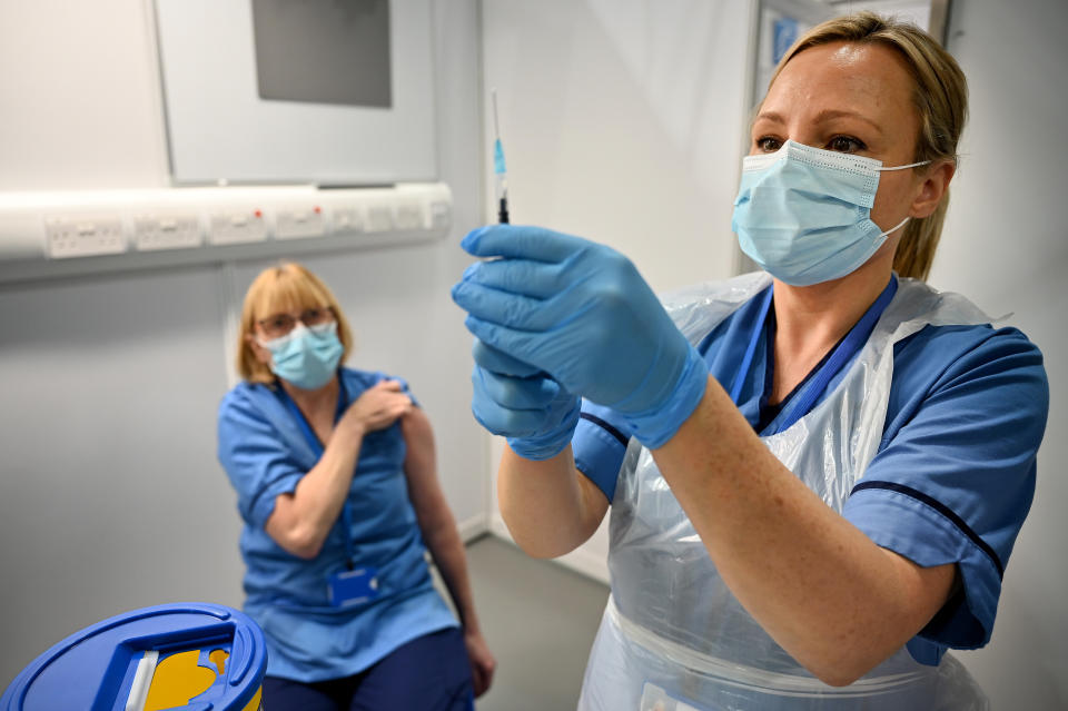 Grace Thomson (left) receives the first of two Pfizer/BioNTech Covid-19 vaccine jabs, administered Paula McMahon, at the NHS Louisa Jordan Hospital in Glasgow, on the first day of the largest immunisation programme in the UK's history. Care home workers, NHS staff and people aged 80 and over began receiving the jab this morning.