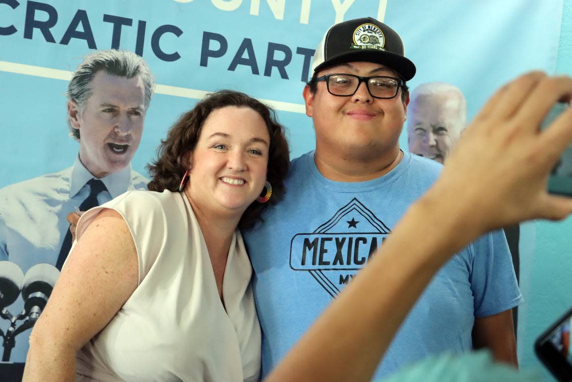 Rep. Katie Porter poses for a photo with Kevin Romero of Mendota during a campaign stop at the Fresno Democratic Party Headquarters in Fresno on Sept. 16, 2023.