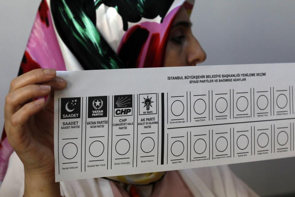 An electoral official holds a ballot at a polling station in Istanbul, Sunday, June 23, 2019. Polls have opened in a repeat election in Turkey's largest city where President Recep Tayyip Erdogan and his political allies could lose control of Istanbul's administration for the first time in 25 years. (AP Photo/Burhan Ozbilici)