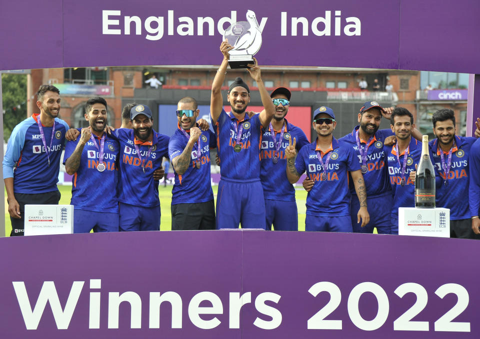 India players celebrate during trophy presentation after India win the third one day international cricket match and the series between England and India at Emirates Old Trafford cricket ground in Manchester, England, Sunday, July 17, 2022. (AP Photo/Rui Vieira)