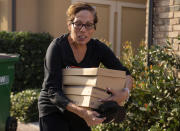 Orchard Hills resident Ruby Johnson takes photos and valuables with her as she and her husband get ready to leave Irvine, Calif., during a mandatory fire evacuate, Monday, Oct. 26, 2020, because of the nearby Silverado wildfire. (Mindy Schauer/The Orange County Register via AP)