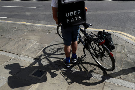 FILE PHOTO: A cyclist prepares to delivery an Uber Eats food order in London, Britain June 8, 2018. REUTERS/Simon Dawson/File Photo