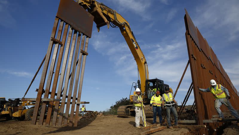 In this Jan. 9, 2019 file photo, construction crews install new border wall sections seen from Tijuana, Mexico. In a letter initiated by Utah Sen. Mitt Romney, he and 14 other Republican senators pressed the Biden administration to “finish the border wall.”