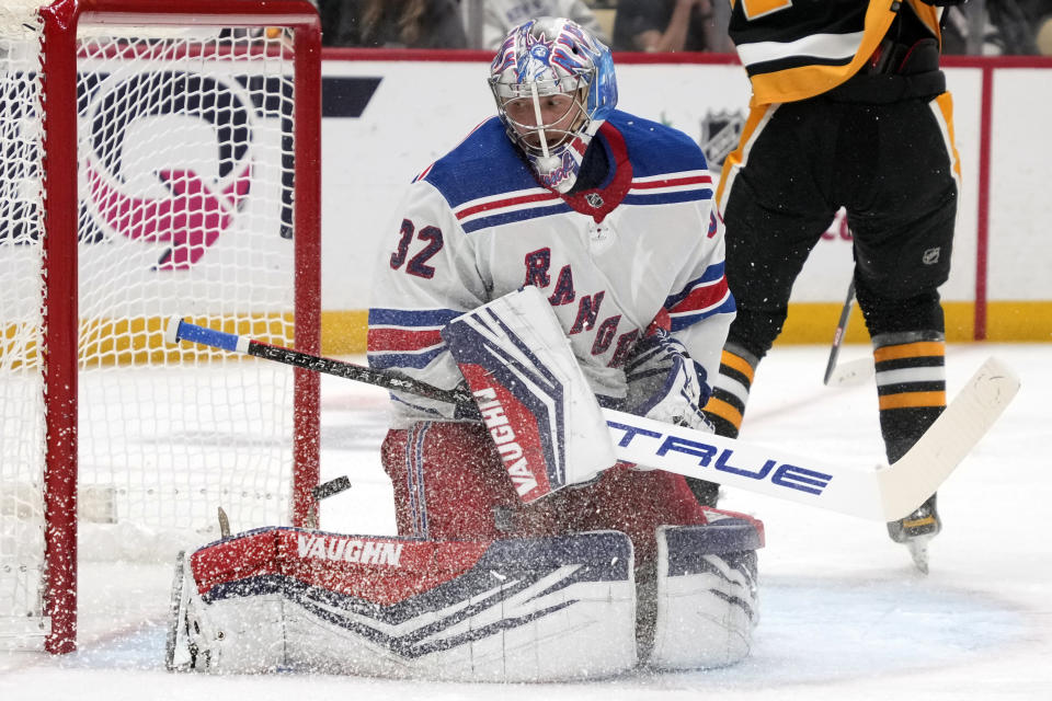 A shot by Pittsburgh Penguins' Drew O'Connor gets behind New York Rangers goaltender Jonathan Quick (32) but stays out of the net during the second period of an NHL hockey game in Pittsburgh, Wednesday, Nov. 22, 2023. (AP Photo/Gene J. Puskar)