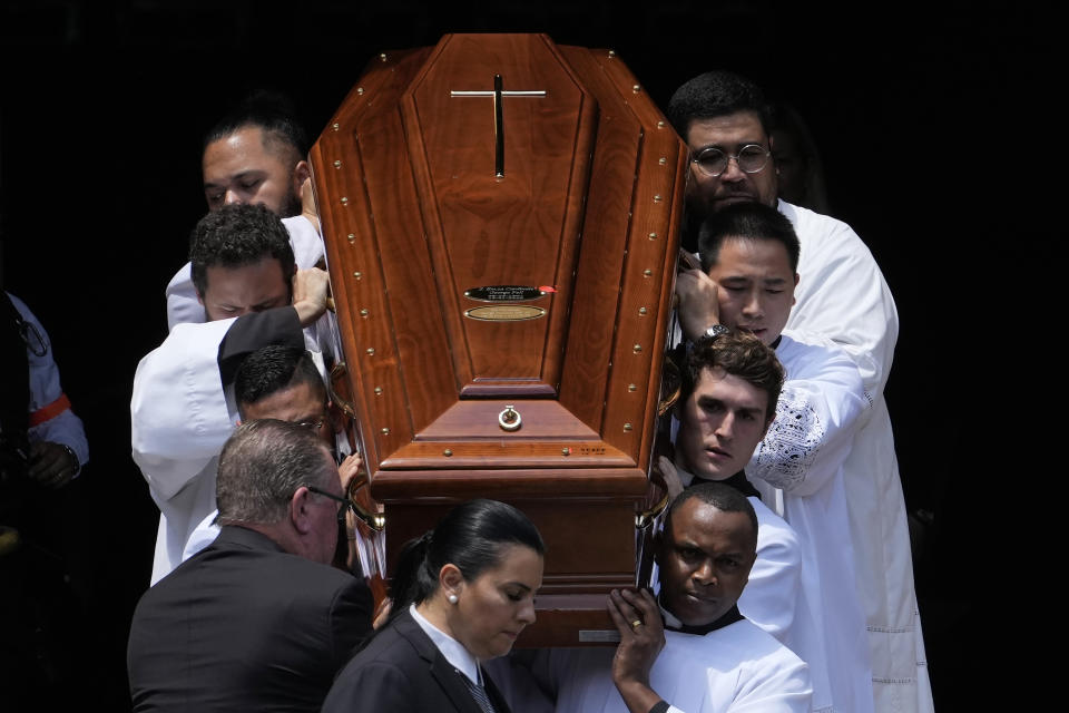 The coffin of Cardinal George Pell is carried out of St. Mary's Cathedral in Sydney, Thursday, Feb. 2, 2023. Pell, who died last month at age 81, spent more than a year in prison before his sex abuse convictions were overturned in 2020. (AP Photo/Rick Rycroft)