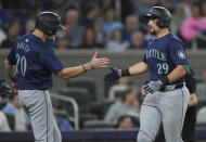 Seattle Mariners' Cal Raleigh (29) celebrates with Luke Raley (20) after hitting the go-ahead, two-run home run against the Toronto Blue Jays during the 10th inning of a baseball game Wednesday, April 10, 2024, in Toronto. (Nathan Denette/The Canadian Press via AP)