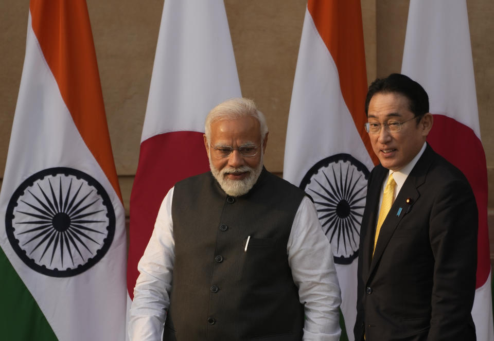 Indian Prime Minister Narendra Modi walks with his Japanese counterpart Fumio Kishida in New Delhi, Saturday, March 19, 2022. Kishida is meeting with Modi to strengthen their partnership in the Indo-Pacific and beyond in view of China's growing footprint in the region, an Indian official said Thursday. (AP Photo/Manish Swarup)