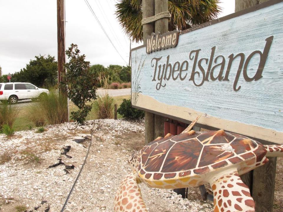 A vehicle passes the welcome sign at the city limits of Tybee Island on Wednesday, Nov. 20, 2013. Tybee Island officials have approved installing roadside scanners that read and store license plate information for every car and truck coming and going on the island. The mayor says the city wants the information for a tourism study, but officials are already getting angry calls and emails from residents who say tracking vehicles is too intrusive. (AP Photo/Russ Bynum)