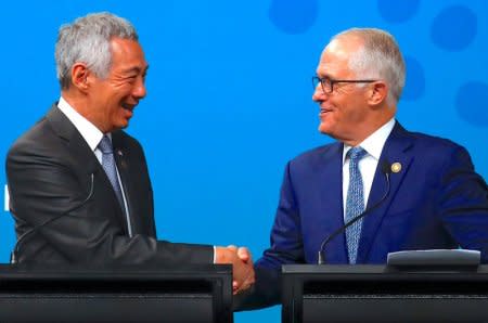 Australian Prime Minister Malcolm Turnbull shakes hands with Prime Minister of Singapore Lee Hsien Loong during their media conference during the one-off summit of 10-member Association of Southeast Asian Nations (ASEAN) in Sydney, Australia, March 18, 2018.     REUTERS/David Gray