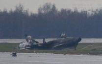 The wreckage of what is believed to be Christophe de Margerie's Dassault Falcon jet is seen at Moscow's Vnukovo airport, October 21, 2014. REUTERS/Maxim Zmeyev