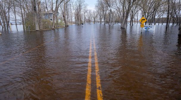 PHOTO: A road along the Mississippi River covered by floodwaters, April 27, 2023, in the Town of Campbell just outside La Crosse, Wis. (Mark Hoffman/Milwaukee Journal via USA Today Network)