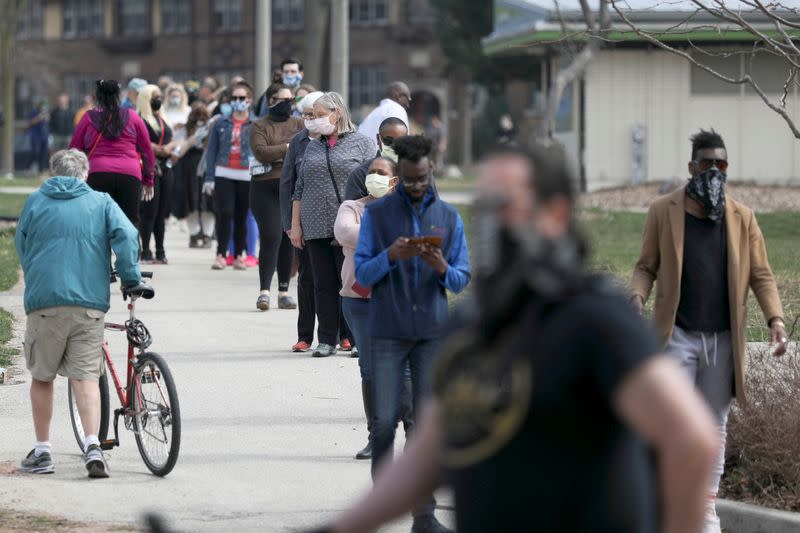 Voters wait to cast ballots during the presidential primary election in Wisconsin