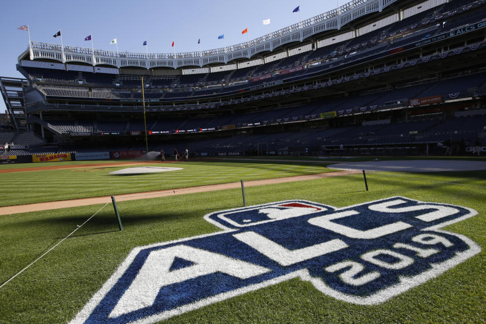 The field is prepped with signage for the American League Championship Series between the New York Yankees and the Houston Astros at Yankee Stadium, Monday, Oct. 14, 2019, in New York. Game 4 in the series, tied at 1-1, is scheduled for Tuesday. (AP Photo/Kathy Willens)