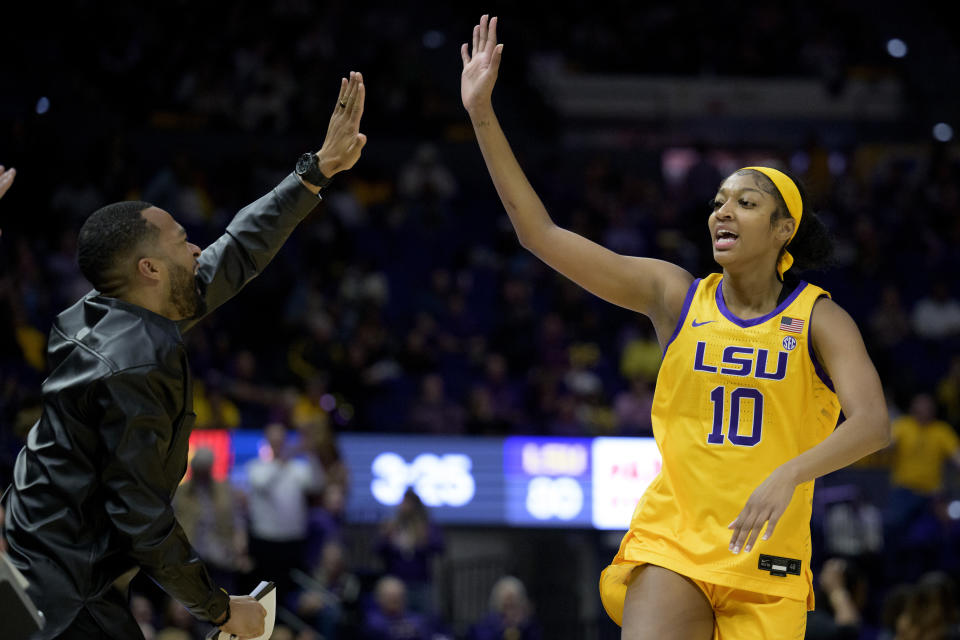 LSU assistant coach Gary Redus II, left, celebrates with LSU guard Ryann Payne (10) in the second half of an NCAA college basketball game against Auburn, Sunday, Jan. 15, 2023, in Baton Rouge, La. (AP Photo/Matthew Hinton)