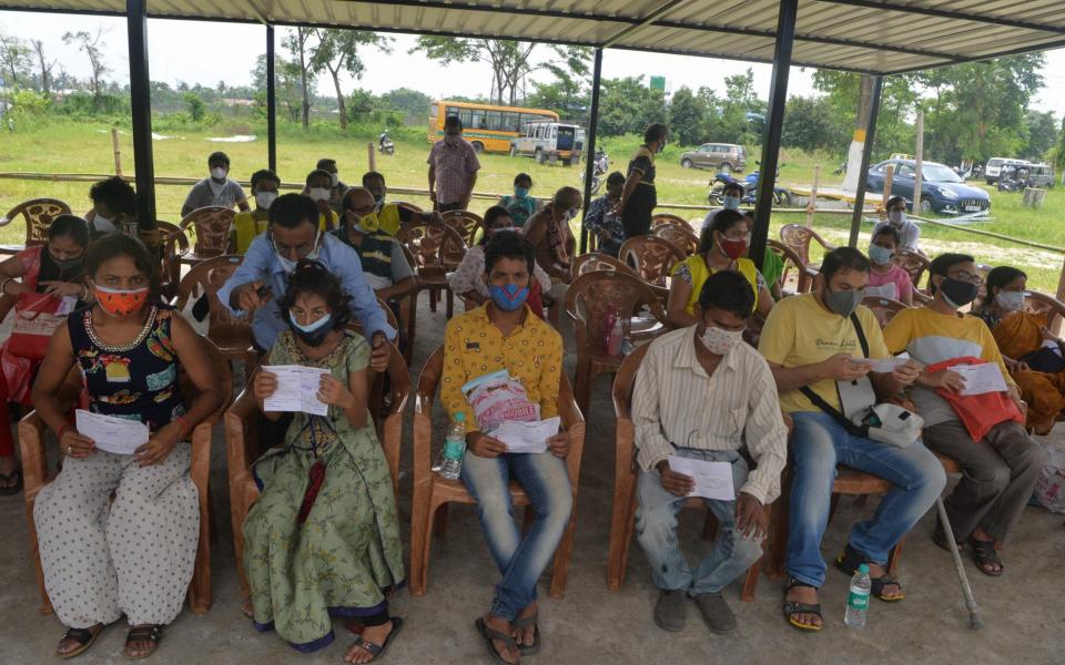 People queue for their vaccinations near Siliguri in India - Diptendu DUTTA / AFP