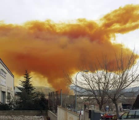 An orange toxic cloud is seen over the town of Igualada, near Barcelona, following an explosion in a chemical plant, February 12, 2015. REUTERS/Ricard Sole Figueras
