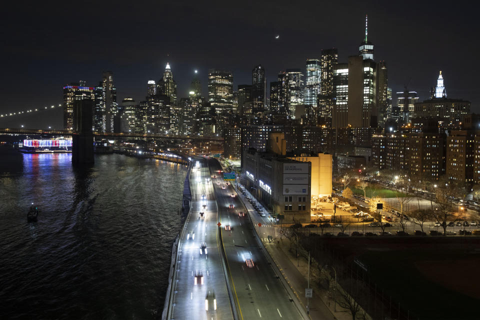 Cars head along FDR Drive next to the Manhattan skyline Thursday, March 26, 2020, during the coronavirus outbreak in New York. The New York City immortalized in song and scene has been swapped out for the last few months with the virus version. In all the unknowing of what the future holds, there's faith in that other quintessential facet of New York City: that the city will adapt. (AP Photo/Mark Lennihan)