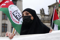 People hold Palestinian flags and banners during a demonstration in Lille, northern France, Saturday May 15, 2021. Marches in support of Palestinians in the Gaza Strip were being held Saturday in a dozen French cities, but the focus was on Paris, where riot police got ready as organizers said they would defy a ban on the protest. (AP Photo/Michel Spingler)