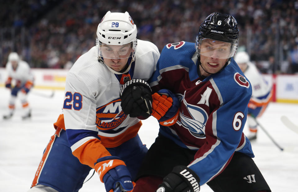 New York Islanders left wing Michael Dal Colle, left, and Colorado Avalanche defenseman Erik Johnson pursue the puck into the corner during the second period of an NHL hockey game Wednesday, Feb. 19, 2020, in Denver. (AP Photo/David Zalubowski)