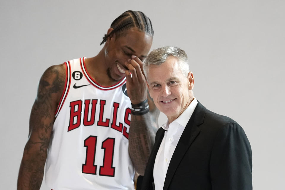 Chicago Bulls head coach Billy Donovan, right, poses for photographers as DeMar DeRozan laughs behind him during the Bulls NBA basketball media day Monday, Sept. 26, 2022, in Chicago. (AP Photo/Charles Rex Arbogast)