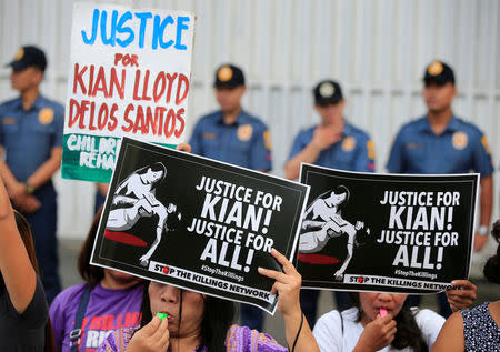 Protesters hold placards seeking justice for 17-year-old high school student Kian delos Santos, who was killed in a recent police raid in an escalation of President Rodrigo Duterte's war on drugs, during a protest in front of the Philippine National Police (PNP) headquarters in Quezon city, Metro Manila, Philippines August 23, 2017. REUTERS/Romeo Ranoco