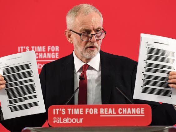 The Labour leader holds up part of the 451-page dossier (EPA)