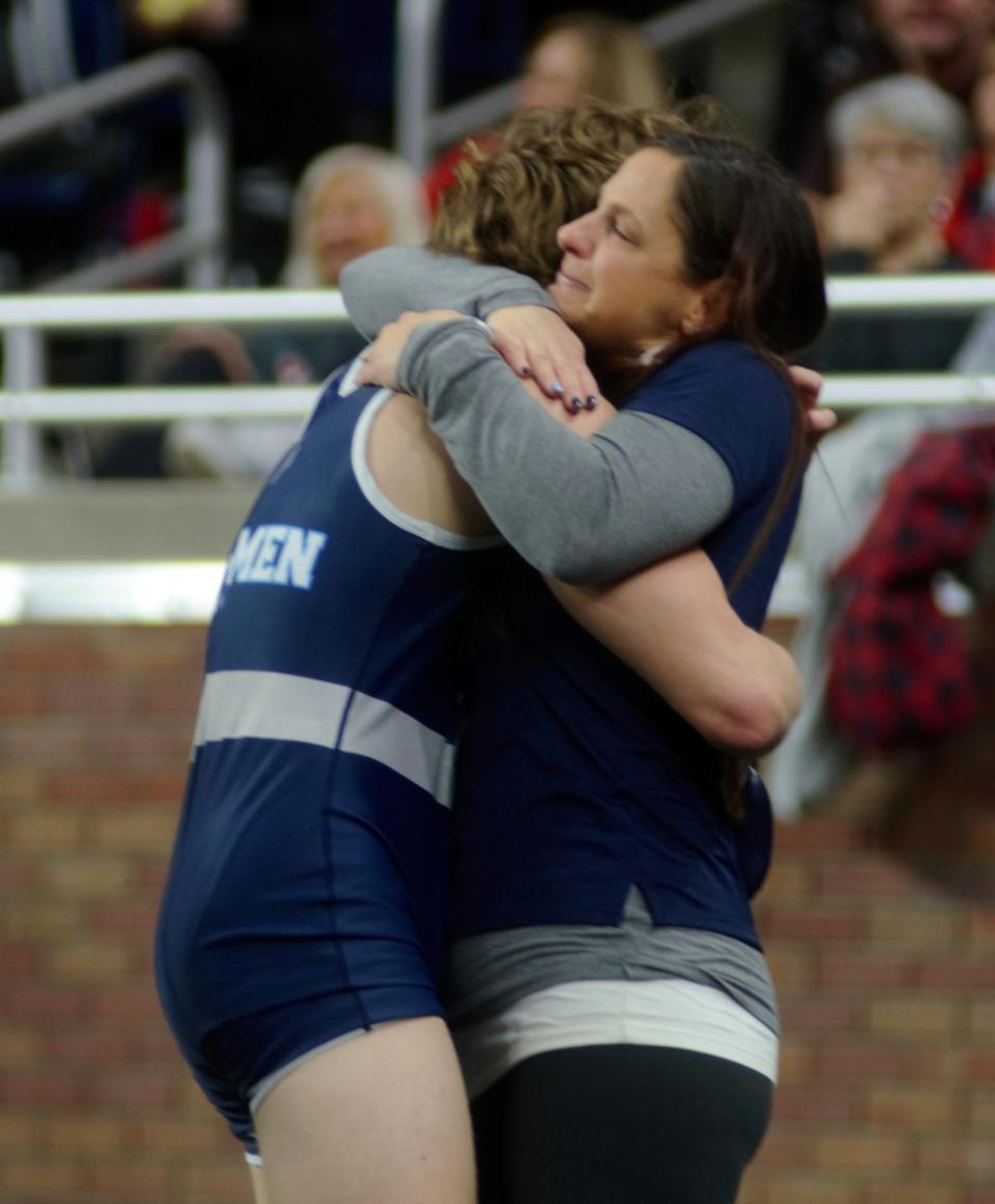 Trevor Swiss embraces his mom, Amanda Swiss, following his state championship match.