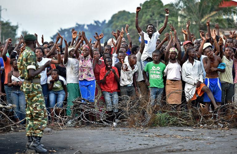 Protesters shout in front of a barricade during a demonstration against Burundian President's third term candidature in the Cibitoke neighborhood of the capital Bujumbura on May 22, 2015