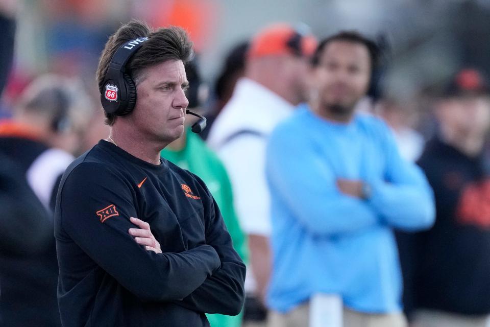 Oklahoma State head coach Mike Gundy watches during the second half of an NCAA college football game against Kansas Saturday, Nov. 5, 2022, in Lawrence, Kan. Kansas won 37-16. (AP Photo/Charlie Riedel)