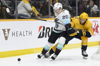 Seattle Kraken right wing Eeli Tolvanen (20) blocks Nashville Predators center Cody Glass from getting to the puck during the first period of an NHL hockey game, Thursday, March 23, 2023, in Nashville, Tenn. (AP Photo/Mark Zaleski)