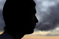 A young man smokes a Suorin Drop electronic cigarette in this picture illustration taken September 14, 2018. REUTERS/Mike Blake/Illustration