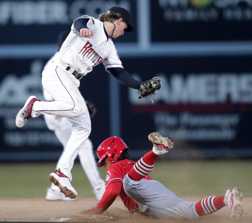 Timber Rattlers second baseman Dylan O'Rae, left, tries to tag Won-Bin Cho of Peoria during a game April 5 at Neuroscience Group Field at Fox Cities Stadium.