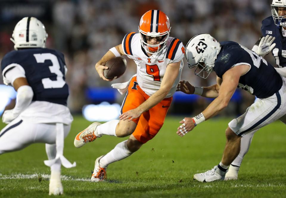 Sep 28, 2024; University Park, Pennsylvania, USA; Illinois Fighting Illini quarterback Luke Altmyer (9) runs while trying against Penn State Nittany Lions linebacker Tyler Elsdon (43) during the second quarter at Beaver Stadium.