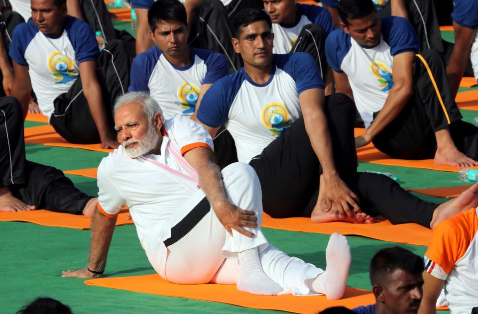 Indian Prime Minister Narendra Modi performs yoga to mark International Day of Yoga in Dehradun, India, on June 21, 2018.