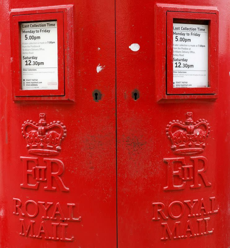 FILE PHOTO: A Royal Mail sign is pictured on a post box outside a Post Office, in St Albans