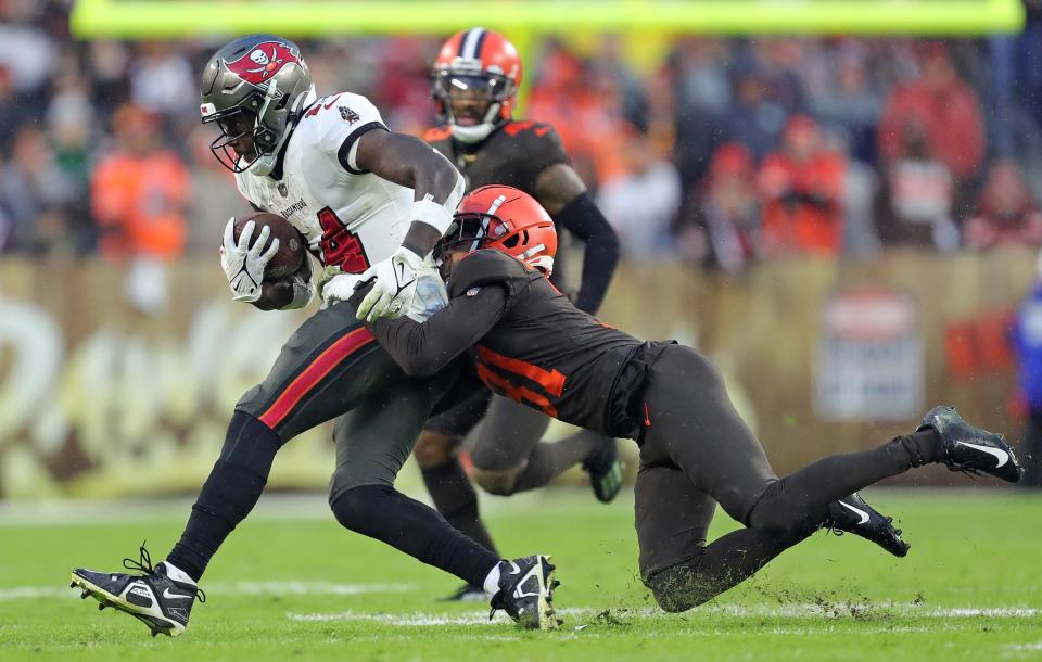 Cleveland Browns cornerback Thomas Graham Jr. (31) brings down Tampa Bay Buccaneers wide receiver Chris Godwin (14) during the second half of an NFL football game at FirstEnergy Stadium, Sunday, Nov. 27, 2022, in Cleveland, Ohio.