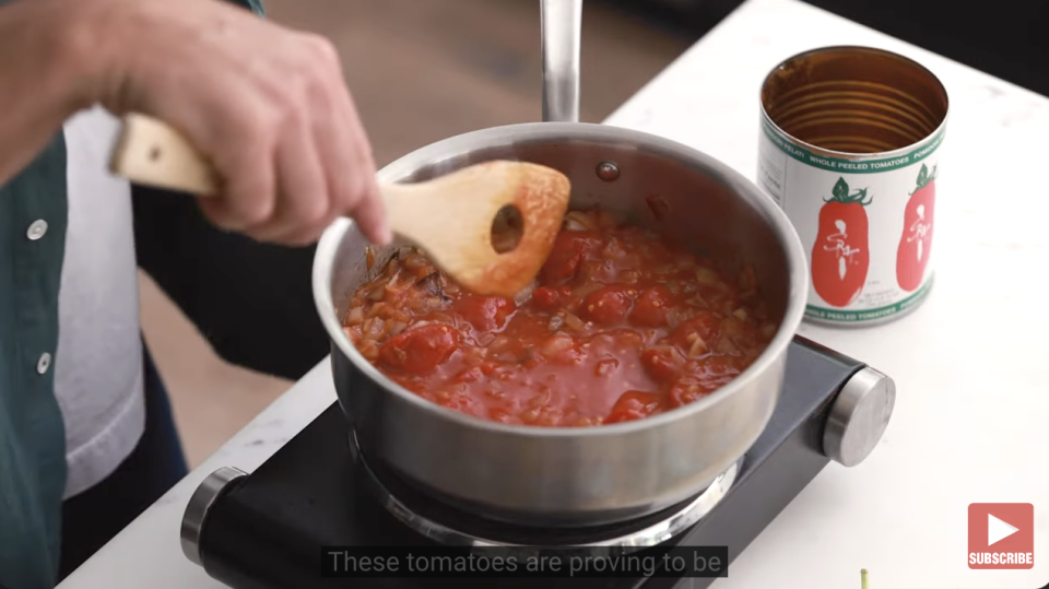 man making marinara sauce at home