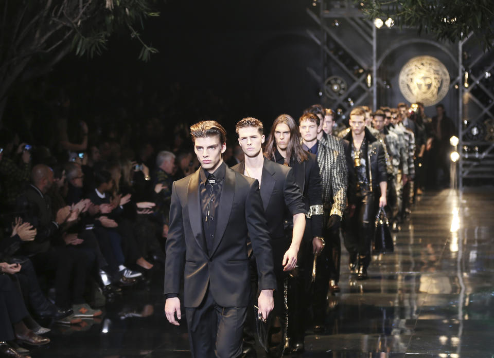 Models wear creations for Versace men's Autumn-Winter 2014 collection, part of the Milan Fashion Week, unveiled in Milan, Italy, Saturday, Jan. 11, 2014. (AP Photo/Antonio Calanni)