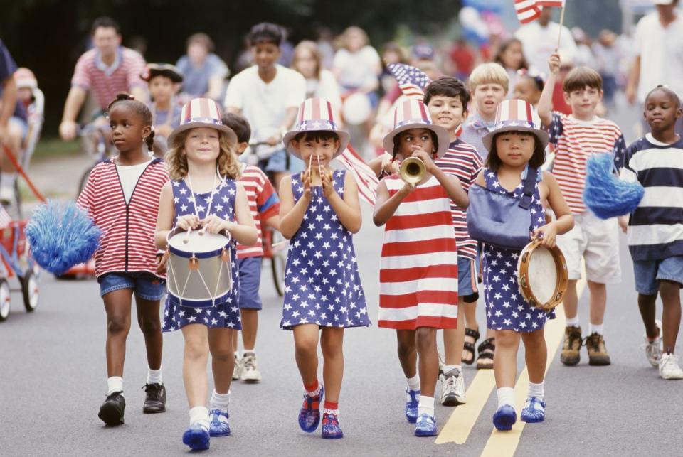 summer activity with children marching in 4th of july parade